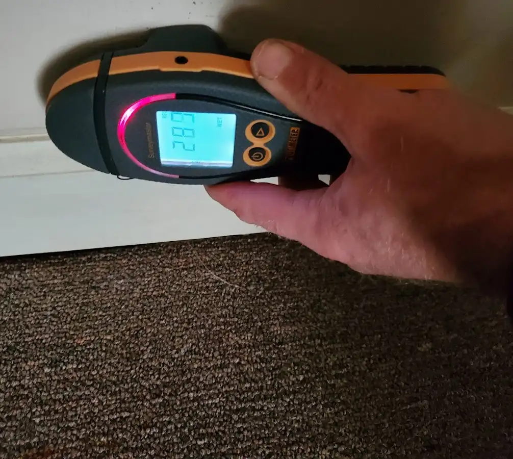 Moisture detection at baseboard during Storm Damage Restoration in Akron
